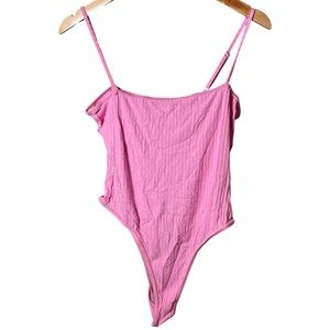 Light pink bodysuit buckles on crotch area
